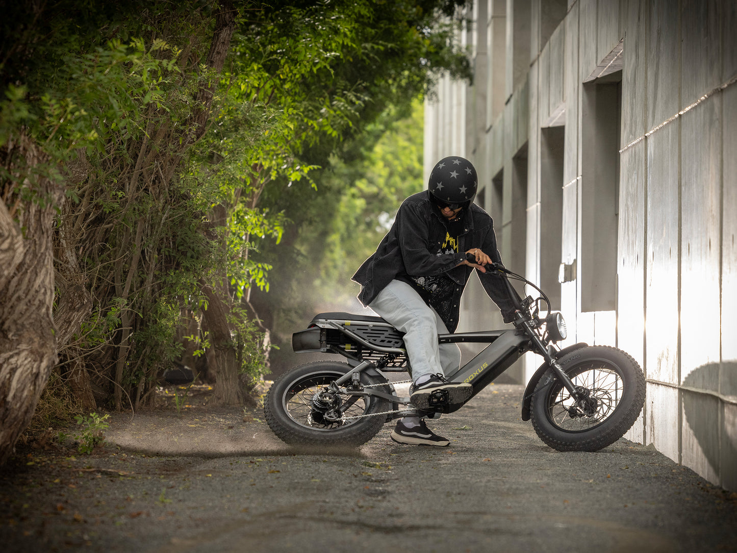 Troxus Lynx 2-Up electric bike performing a controlled skid on a gravel trail 