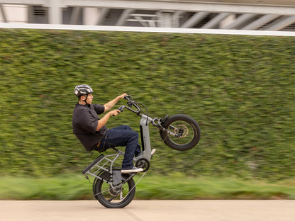 Rider performing a wheelie on a Troxus Lynx 2-Up electric bike